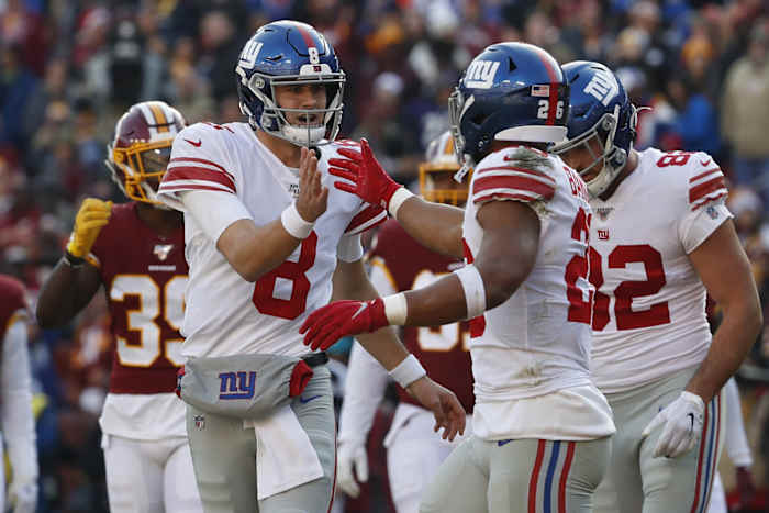Dec 22, 2019; Landover, Maryland, USA; New York Giants quarterback Daniel Jones (8) celebrates with Giants running back Saquon Barkley (26) after connecting on a touchdown pass against the Washington Redskins in the second quarter at FedExField.